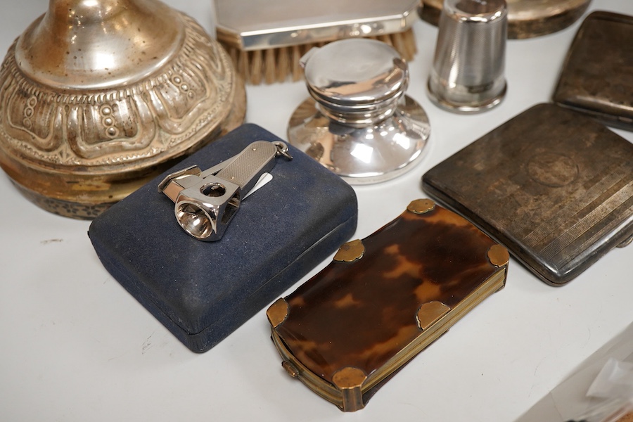 A George V silver top opening cigarette case, Birmingham, 1923, 83mm, together with a silver mounted hair brush, one other silver cigarette case, a silver mounted cigar cutter, a silver mounted inkwell, a large silver th
